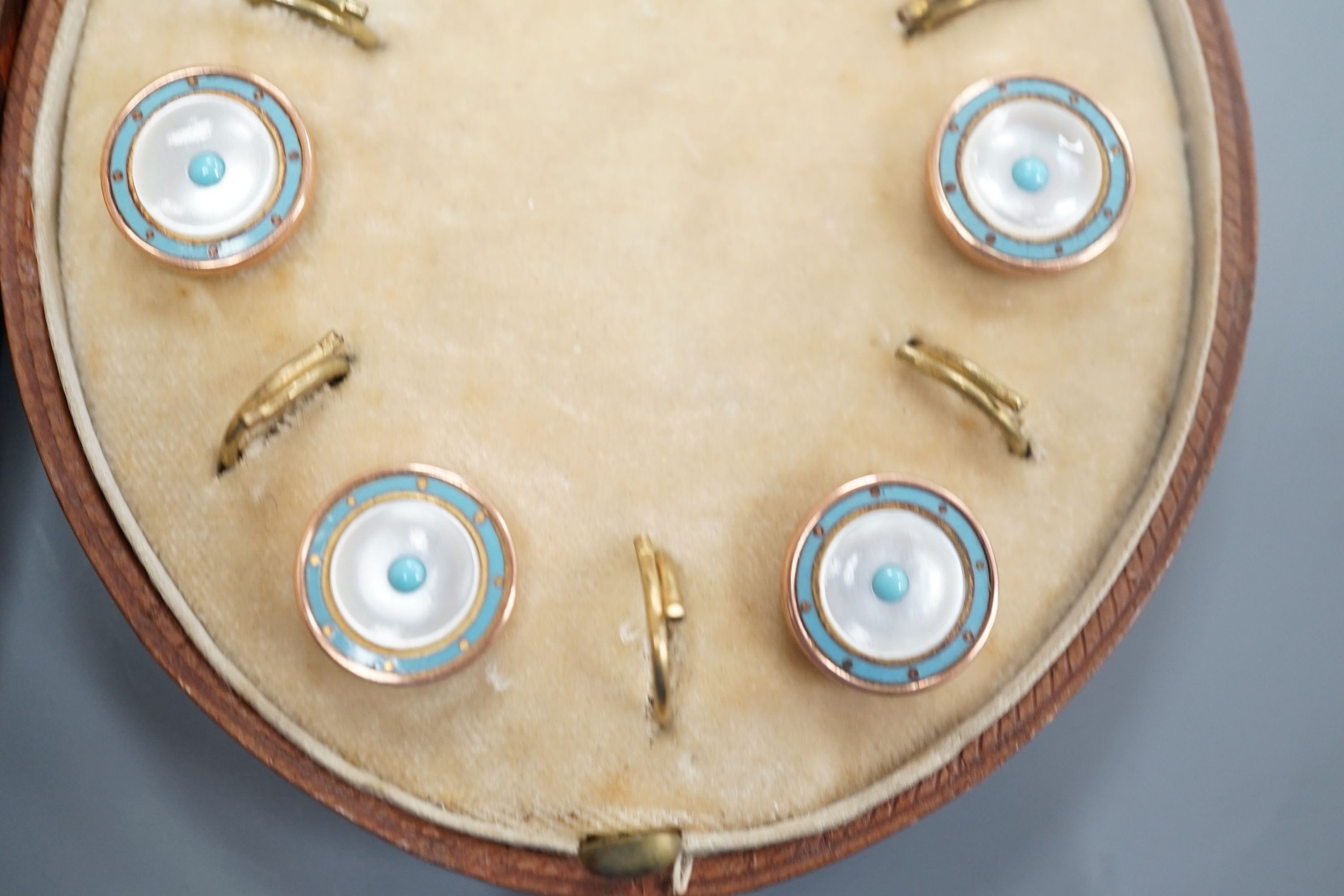 A cased early 20th century six piece gilt metal, mother of pearl and enamel dress stud set and four pairs of silver or white metal cufflinks.
